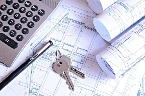 Calculadora e chaves de casa, representando o financiamento imobiliário